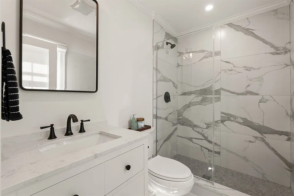 Bathroom with a marble shower in the Amesbury home