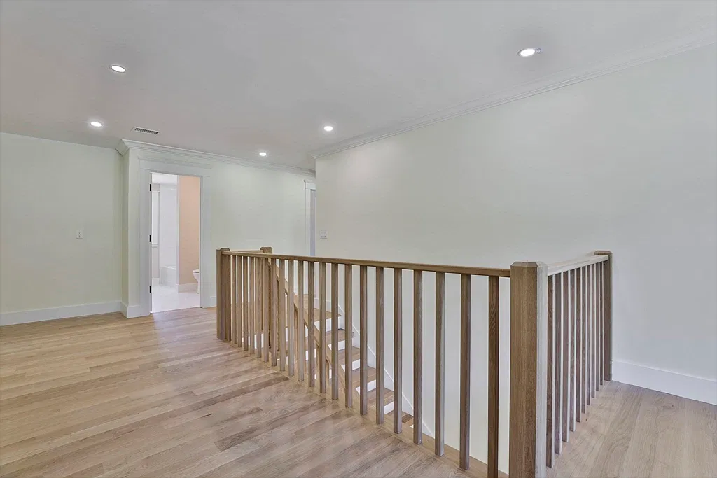 Upstairs landing and wood railing in the Amesbury home