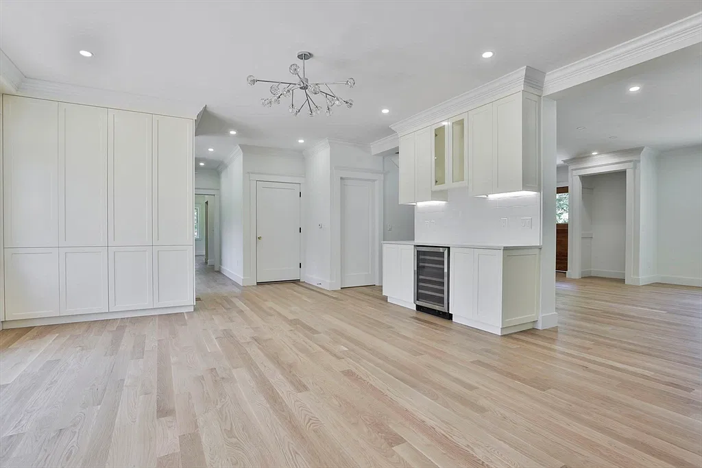 White built-in cabinets and a renovated kitchen bar