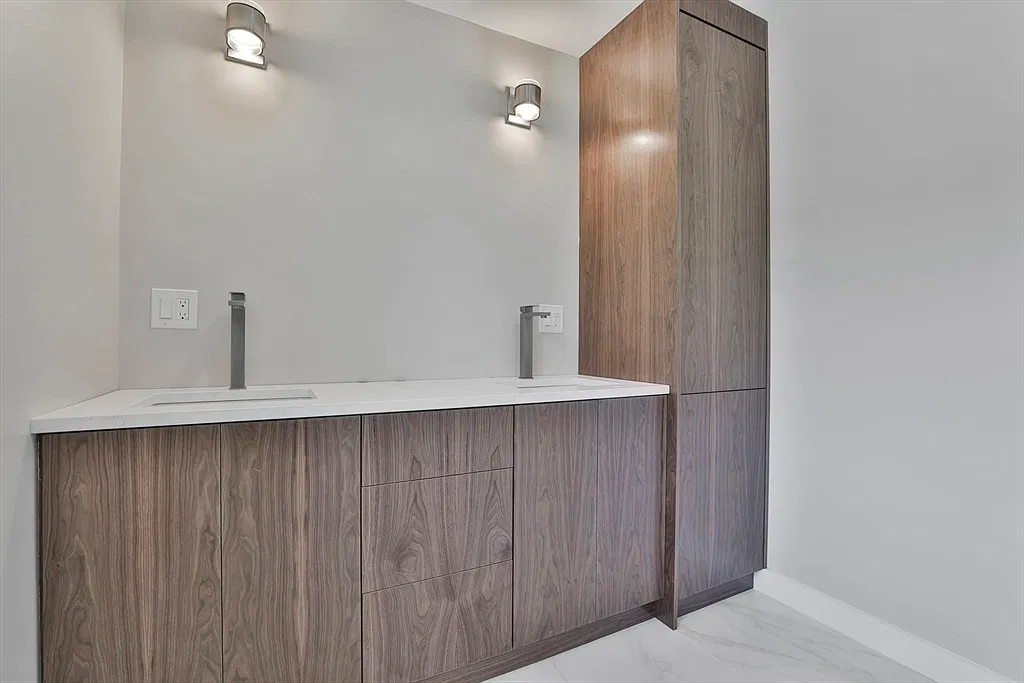 Walnut bathroom vanity with a white countertop